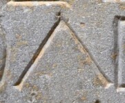 A close-up of an instance of allograph Λ type2 inscribed on object ISic001155