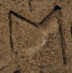 A close-up of an instance of allograph Μ type1 inscribed on object ISic001466