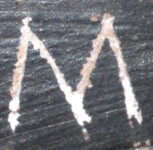 A close-up of an instance of allograph Μ type2 inscribed on object ISic020298