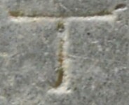 A close-up of an instance of allograph Τ type2.2 inscribed on object ISic000827