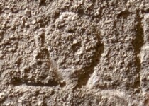 A close-up of an instance of allograph   inscribed on an object