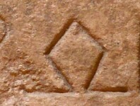 A close-up of an instance of allograph   inscribed on an object