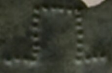 A close-up of an instance of allograph   inscribed on an object