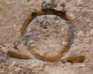A close-up of an instance of allograph   inscribed on an object