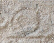 A close-up of an instance of allograph   inscribed on an object