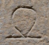 A close-up of an instance of allograph   inscribed on an object