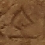 A close-up of an instance of allograph   inscribed on an object