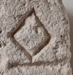 A close-up of an instance of allograph   inscribed on an object