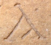 A close-up of an instance of allograph   inscribed on an object