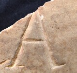 A close-up of an instance of allograph   inscribed on an object