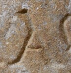 A close-up of an instance of allograph   inscribed on an object