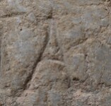 A close-up of an instance of allograph   inscribed on an object