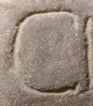 A close-up of an instance of allograph   inscribed on an object