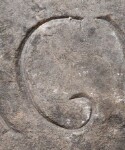 A close-up of an instance of allograph   inscribed on an object