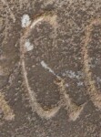 A close-up of an instance of allograph   inscribed on an object