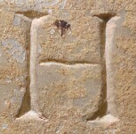 A close-up of an instance of allograph   inscribed on an object