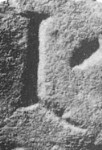 A close-up of an instance of allograph   inscribed on an object