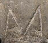 A close-up of an instance of allograph   inscribed on an object