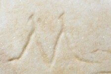 A close-up of an instance of allograph   inscribed on an object