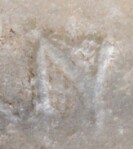 A close-up of an instance of allograph   inscribed on an object