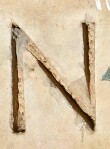 A close-up of an instance of allograph   inscribed on an object