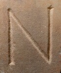 A close-up of an instance of allograph   inscribed on an object