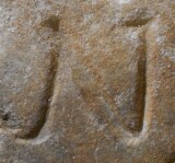 A close-up of an instance of allograph   inscribed on an object