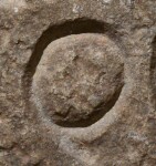 A close-up of an instance of allograph   inscribed on an object