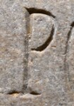 A close-up of an instance of allograph   inscribed on an object