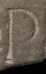 A close-up of an instance of allograph   inscribed on an object