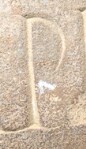 A close-up of an instance of allograph   inscribed on an object