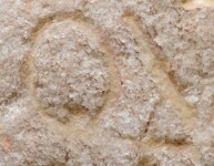 A close-up of an instance of allograph   inscribed on an object