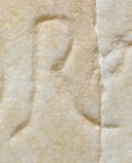 A close-up of an instance of allograph   inscribed on an object