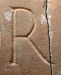 A close-up of an instance of allograph   inscribed on an object