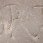 A close-up of an instance of allograph   inscribed on an object