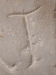 A close-up of an instance of allograph   inscribed on an object