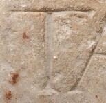 A close-up of an instance of allograph   inscribed on an object