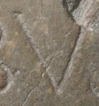 A close-up of an instance of allograph   inscribed on an object