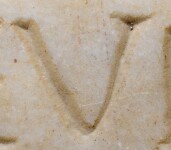 A close-up of an instance of allograph   inscribed on an object