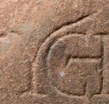 A close-up of an instance of allograph   inscribed on an object