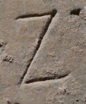 A close-up of an instance of allograph   inscribed on an object